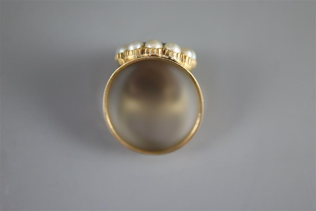 A George IV gold, black enamel, oval cut foil backed garnet and split pearl cluster set mourning ring,